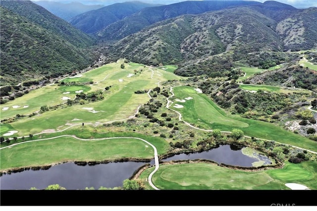 bird's eye view of a water and mountain view and a golf club