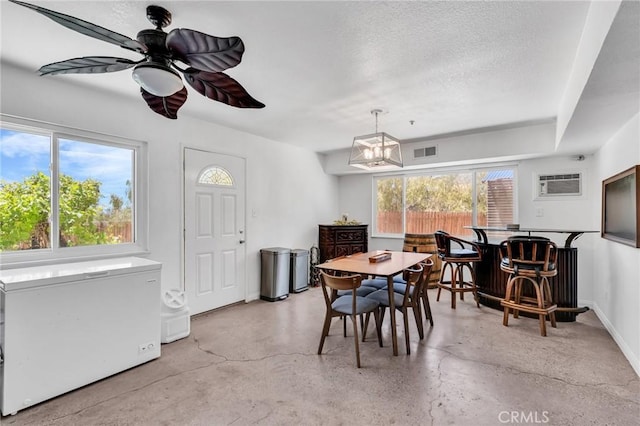 33645 Kobe Rd, Agua Dulce, CA 91390 - dining area with a wall unit AC, ceiling fan, baseboards, concrete floors, and a chandelier