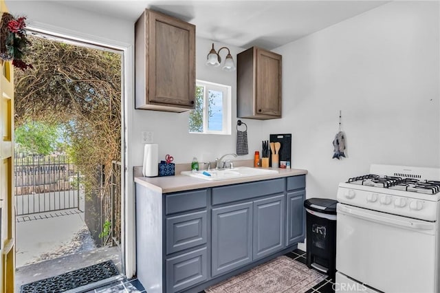33645 Kobe Rd, Agua Dulce, CA 91390 - kitchen featuring white range with gas stovetop, a sink, light countertops, and tile patterned flooring