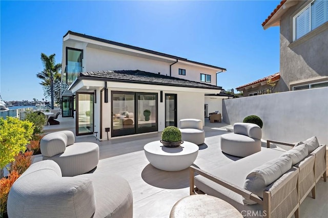 view of patio with an outdoor living space and fence
