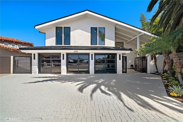 view of front of house with stucco siding and a garage