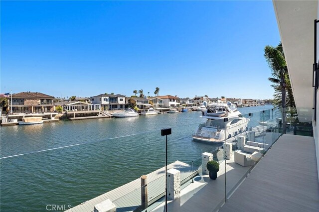 dock area featuring a water view and a residential view
