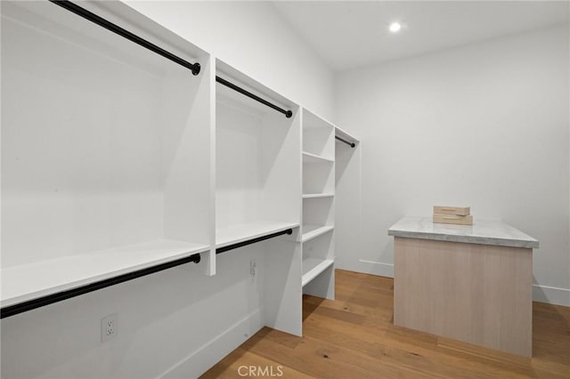 walk in closet featuring light wood finished floors