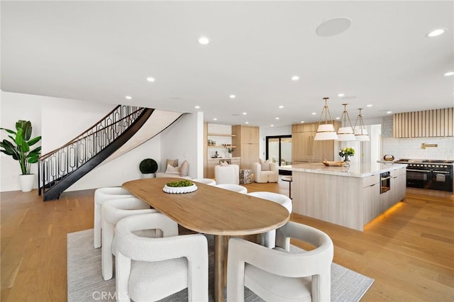 dining area with stairway, recessed lighting, and light wood-style flooring
