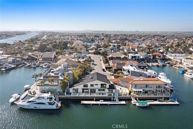 aerial view of residential area featuring a large body of water