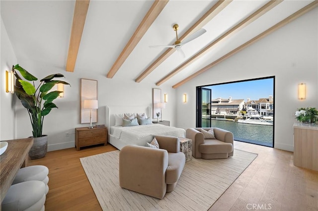 bedroom featuring access to exterior, wood finished floors, baseboards, a water view, and ceiling fan