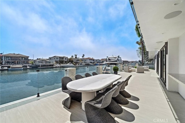 view of patio / terrace featuring a water view, outdoor lounge area, and outdoor dining space