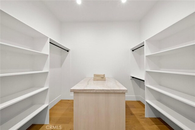 walk in closet featuring light wood finished floors
