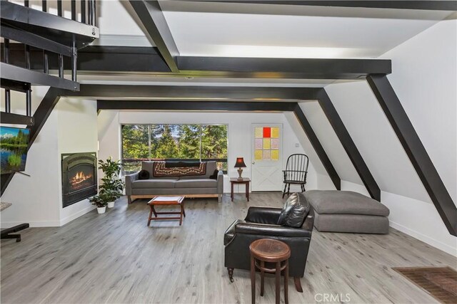 323 Mittry Ln, Lake Arrowhead, CA 92352 - living area featuring beam ceiling, wood finished floors, a lit fireplace, and baseboards