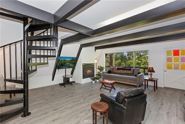 323 Mittry Ln, Lake Arrowhead, CA 92352 - living room with wood finished floors, stairway, baseboards, and a warm lit fireplace