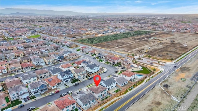 16708 Yarrow Ln, Fontana, CA 92336 - aerial overview of property's location with a mountain backdrop and nearby suburban area