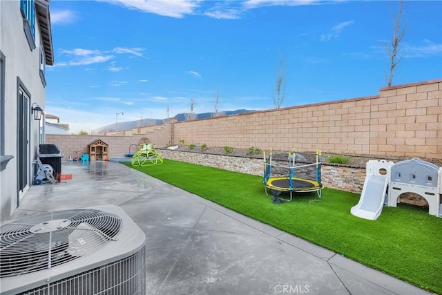 16708 Yarrow Ln, Fontana, CA 92336 - view of patio featuring a trampoline and central AC unit