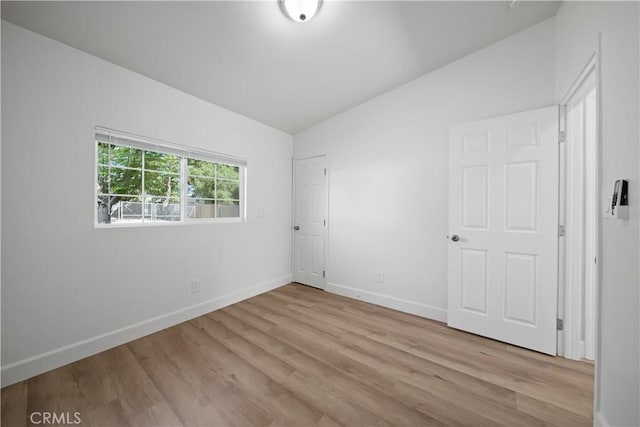 8975 Curbaril Ave, Atascadero, CA 93422 - unfurnished bedroom featuring baseboards, wood finished floors, and vaulted ceiling