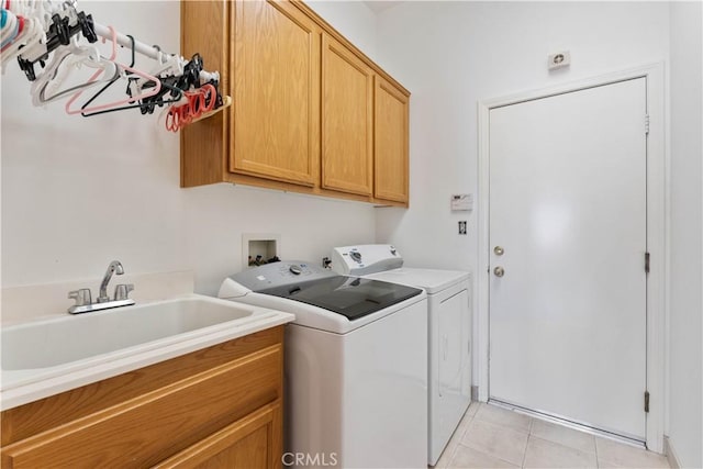 11556 Caldy Ave, Loma Linda, CA 92354 - clothes washing area with washing machine and clothes dryer, cabinet space, and light tile patterned floors