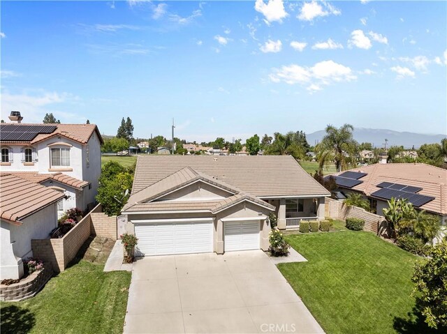 11556 Caldy Ave, Loma Linda, CA 92354 - view of front of house featuring driveway, a garage, a tiled roof, a residential view, and stucco siding