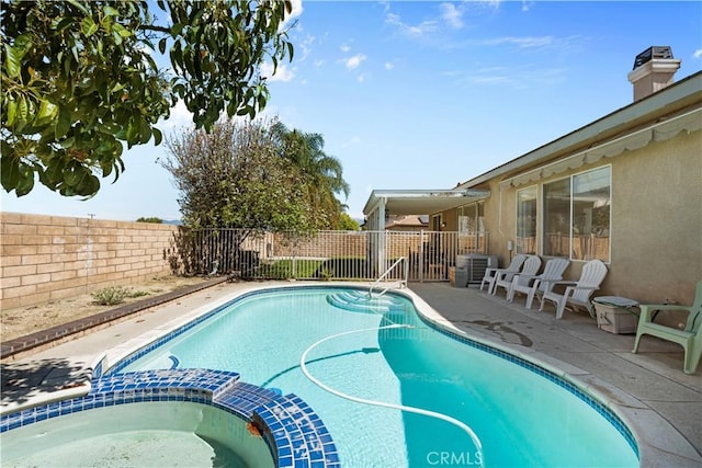 11556 Caldy Ave, Loma Linda, CA 92354 - view of swimming pool with a pool with connected hot tub, a fenced backyard, central AC, and a patio area