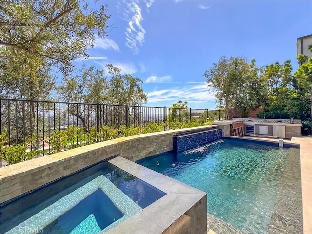 view of pool with an in-ground hot tub, a fenced backyard, and area for grilling