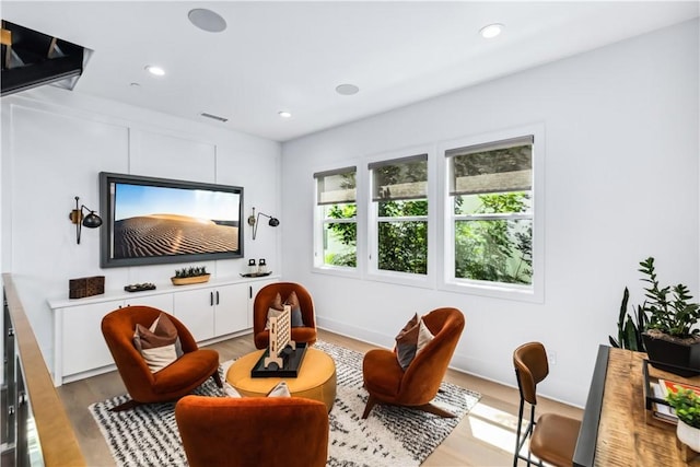 sitting room featuring wood finished floors and recessed lighting