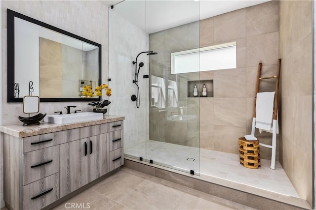full bath featuring walk in shower, vanity, and tile patterned floors
