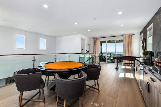 playroom featuring wood-type flooring, plenty of natural light, and recessed lighting