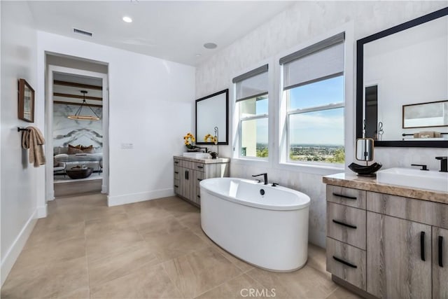 full bathroom with a freestanding bath and two vanities