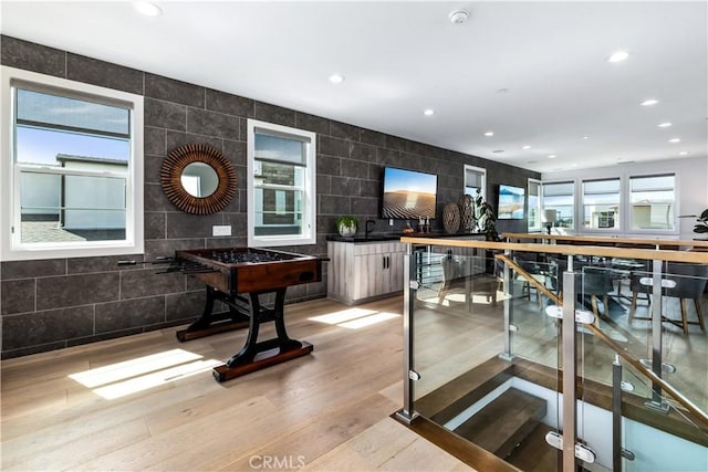 bar featuring light wood-type flooring, recessed lighting, and tile walls