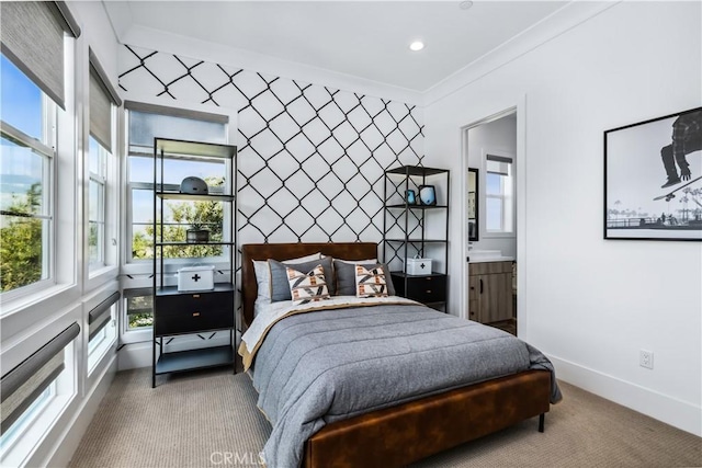 bedroom with carpet, ornamental molding, baseboards, recessed lighting, and connected bathroom