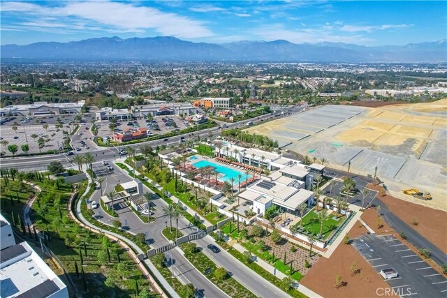 aerial view of property's location featuring a mountain backdrop and a pool area