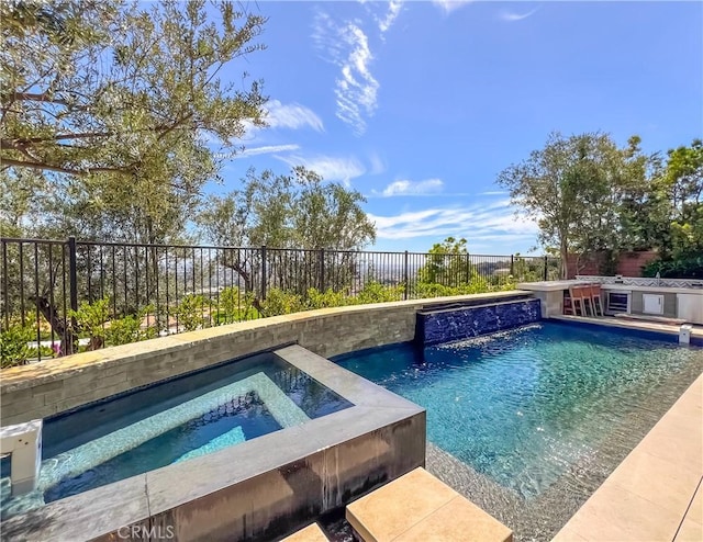 view of swimming pool featuring an in-ground hot tub and a fenced backyard