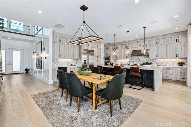 dining space featuring recessed lighting and light wood finished floors
