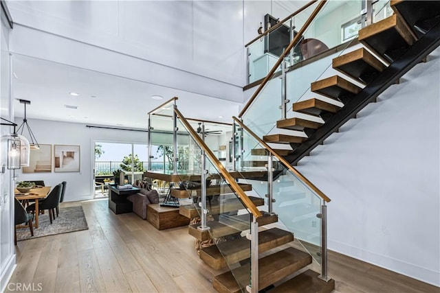 stairs with hardwood / wood-style flooring, baseboards, recessed lighting, and a ceiling fan