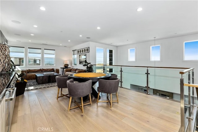 dining room with light wood finished floors and recessed lighting