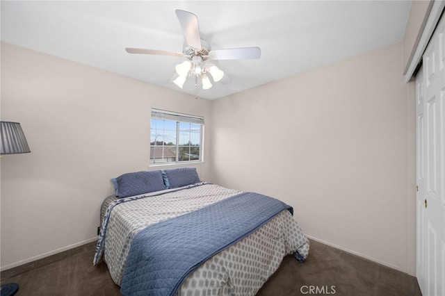 carpeted bedroom with a closet, a ceiling fan, and baseboards