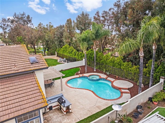 view of pool with a fenced backyard, a patio, outdoor dining space, a pool with connected hot tub, and view of wooded area