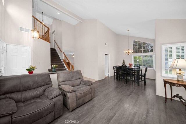 living room with high vaulted ceiling, a chandelier, stairway, and wood finished floors