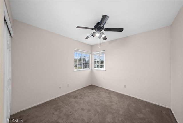 spare room featuring carpet floors, ceiling fan, and baseboards
