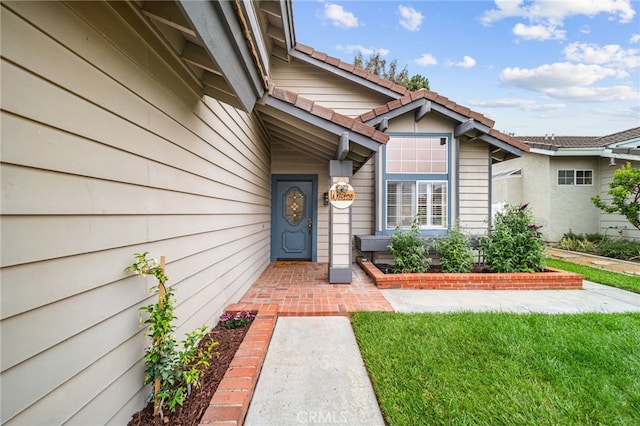 property entrance featuring a tiled roof