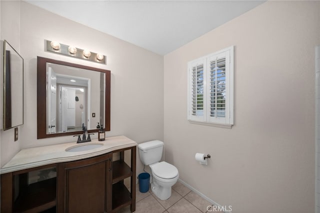 bathroom featuring tile patterned floors, toilet, vanity, and baseboards