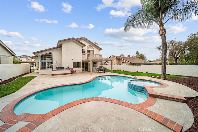 view of pool featuring a fenced backyard, a patio area, and a pool with connected hot tub