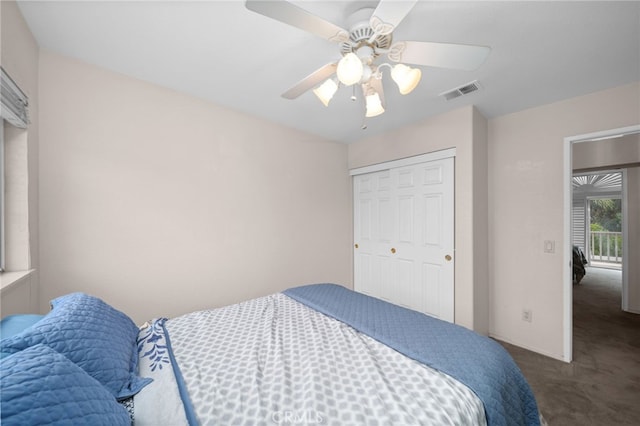 bedroom with dark carpet, a closet, ceiling fan, and baseboards