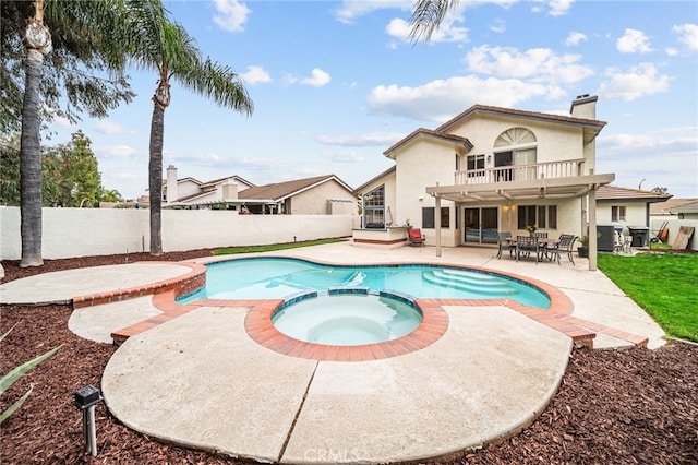 view of swimming pool with a fenced backyard, a pool with connected hot tub, a patio area, and outdoor dining area
