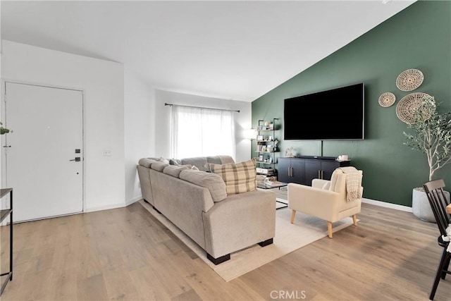 6154 Goldenrod Ln, Riverside, CA 92504 - living area with lofted ceiling, light wood finished floors, and baseboards