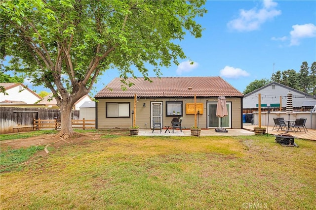 6154 Goldenrod Ln, Riverside, CA 92504 - rear view of property featuring a fire pit, a tiled roof, and a patio area