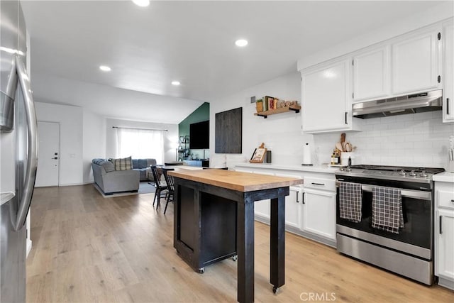 6154 Goldenrod Ln, Riverside, CA 92504 - kitchen featuring under cabinet range hood, stainless steel appliances, butcher block counters, tasteful backsplash, and white cabinets