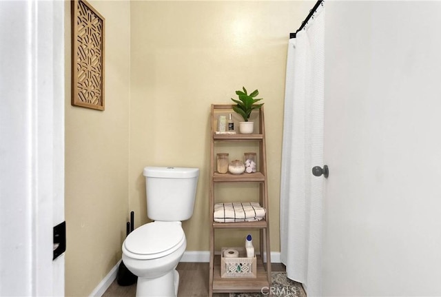 6154 Goldenrod Ln, Riverside, CA 92504 - bathroom with toilet, wood finished floors, and baseboards
