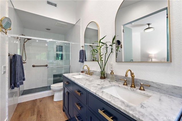 1225 Via Presa, San Clemente, CA 92672 - bathroom featuring a shower stall, toilet, double vanity, and wood finished floors