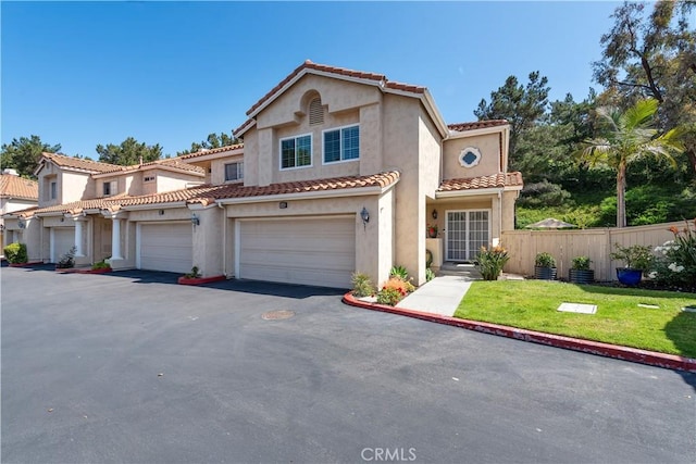 1225 Via Presa, San Clemente, CA 92672 - mediterranean / spanish-style home featuring stucco siding, a tile roof, asphalt driveway, and a garage