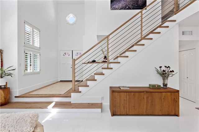 1225 Via Presa, San Clemente, CA 92672 - entryway with a towering ceiling, stairway, tile patterned flooring, and baseboards