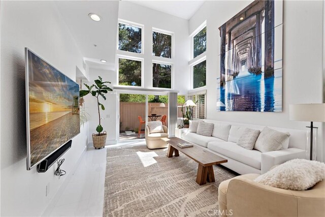 1225 Via Presa, San Clemente, CA 92672 - living room featuring plenty of natural light, a towering ceiling, recessed lighting, and baseboards