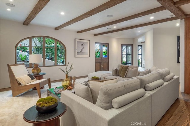 living area featuring recessed lighting, beamed ceiling, wood finished floors, and baseboards